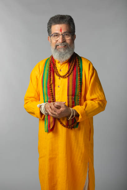 istock Old priest with rudraksha posing on white background 2206460937