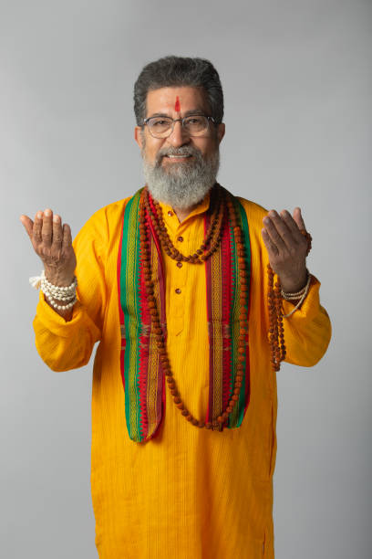 istock Old priest with rudraksha posing on white background 2206461092