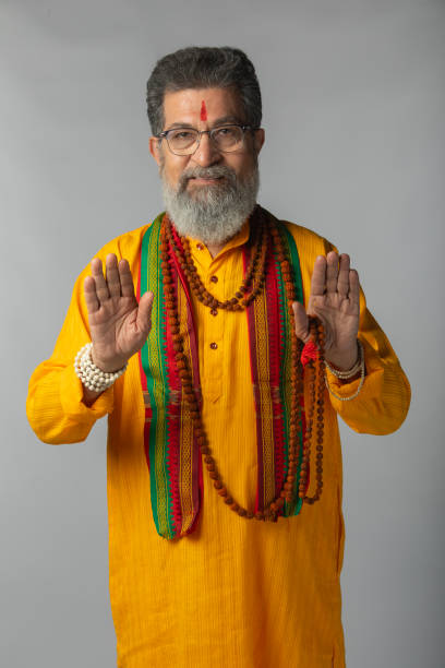istock Old priest with rudraksha posing on white background 2206461107