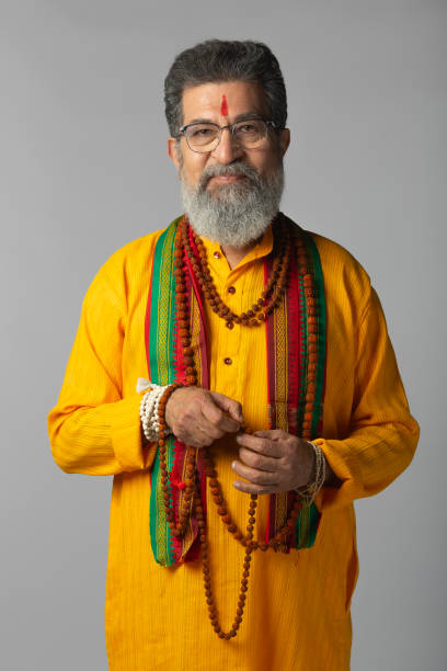 istock Old priest with rudraksha posing on white background 2206461665