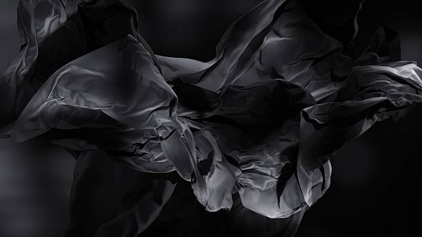 istock A dark wave of material sweeps through the frame like a silent breeze.
– Elegant cloth ripples mid-air, resembling fluid motion in low light. 2206461782