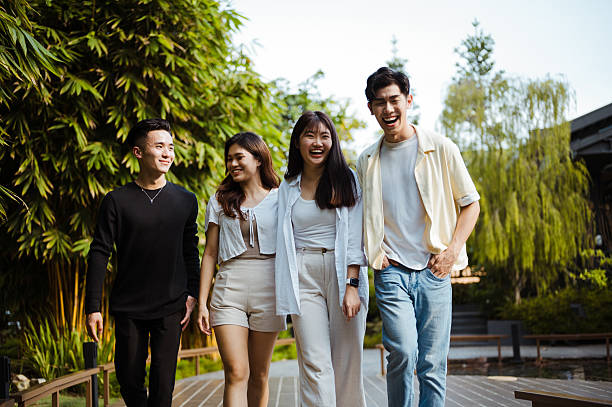 istock Young friends walking in city park and having fun. 2206462164