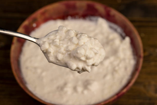 istock cottage cheese made from lumps with cream close-up 2206464218