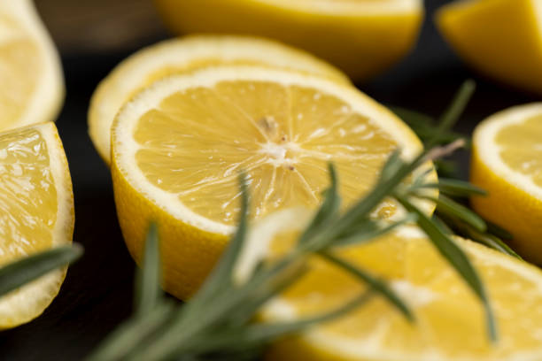 yellow lemon on a black slate board, freshly sliced lemon on a black board close up