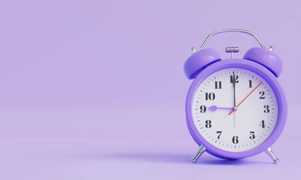 istock Purple alarm clock on soft purple color background 2206465848