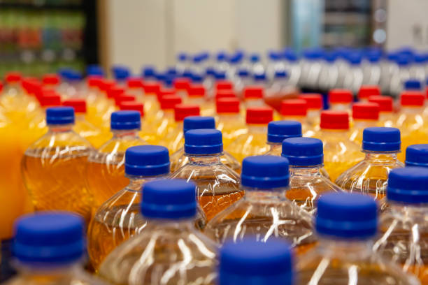 istock Assorted plastic beverage bottles with blue caps in supermarket aisle, emphasizing retail and packaging concepts 2206466151