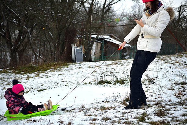 Woman and her dog in Winter landscape in garden covered with snow. Copy space