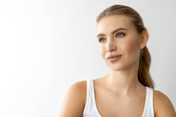 Beautiful female standing against white background