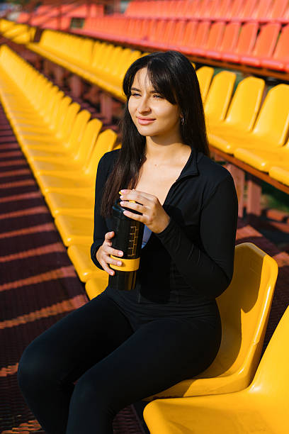 istock Young Woman On Colorful Stadium Seats 2206470888