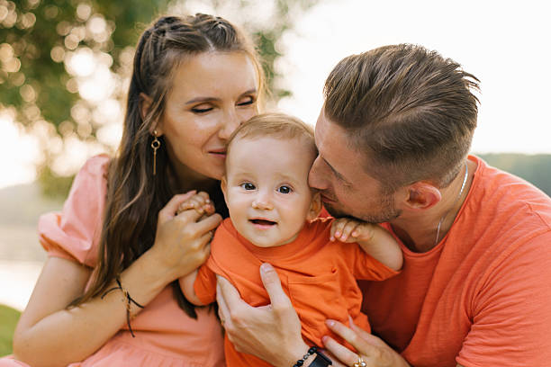 istock Loving Parents Holding Their Baby 2206471719