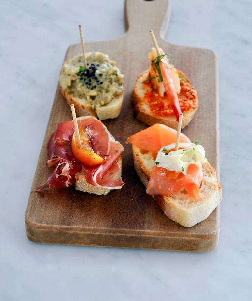 istock Canapes, mixed seafood and meat on bread 2206474336