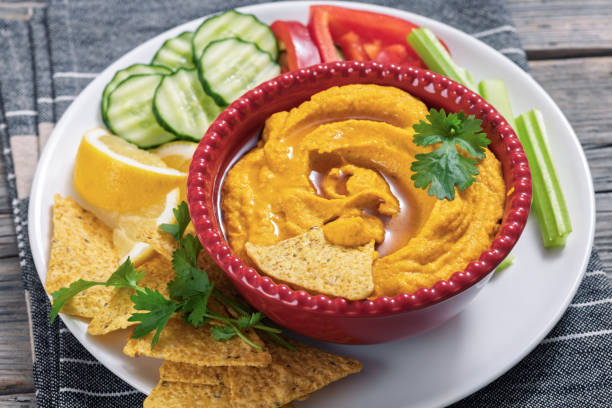 istock creamy roast carrot hummus in red bowl 2206475605