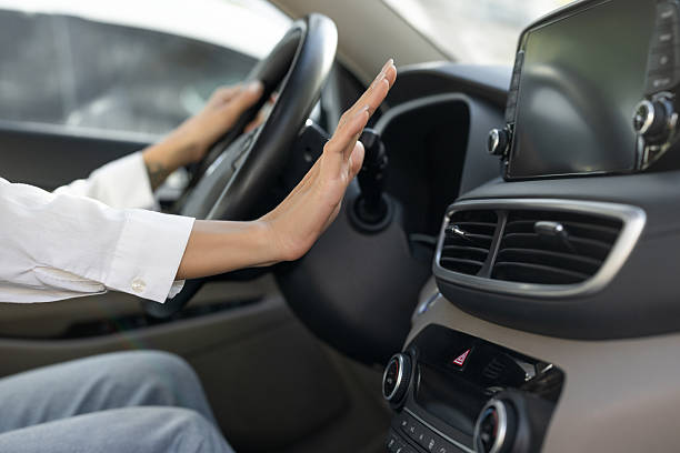 Unrecognizable woman checking car heat