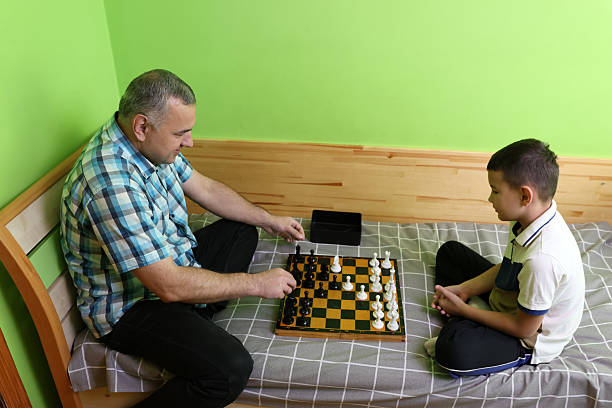 A man and his son are playing chess