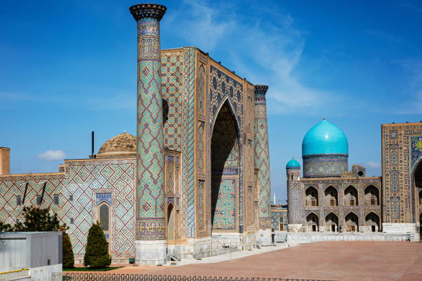 istock Registan Square in Samarkand, Uzbekistan, a historic architectural ensemble featuring three stunning madrasas with intricate mosaic designs, domes, and minarets under a bright blue sky 2206478306