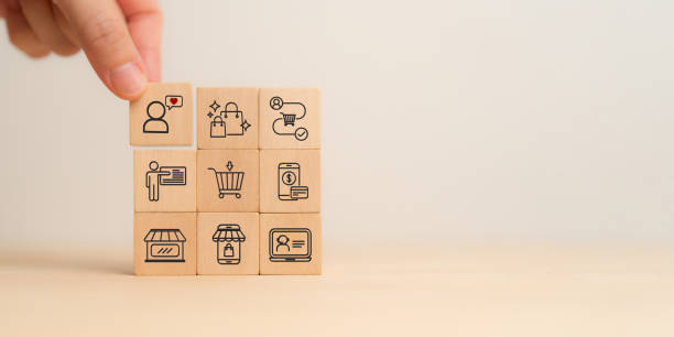 istock Seamless customer experience concept.  A close-up image of a hand selecting a wooden block with a customer icon and heart symbol, representing customer satisfaction, customer experience and engagement 2206478389