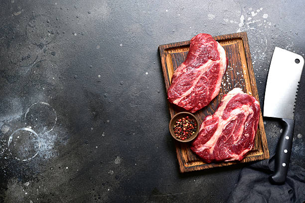 istock Raw organic marbled beef steak with ingredients for cooking . Top view with copy space. 2206478824