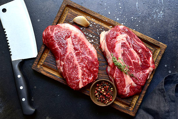 istock Raw organic marbled beef steak with ingredients for cooking . Top view with copy space. 2206479036