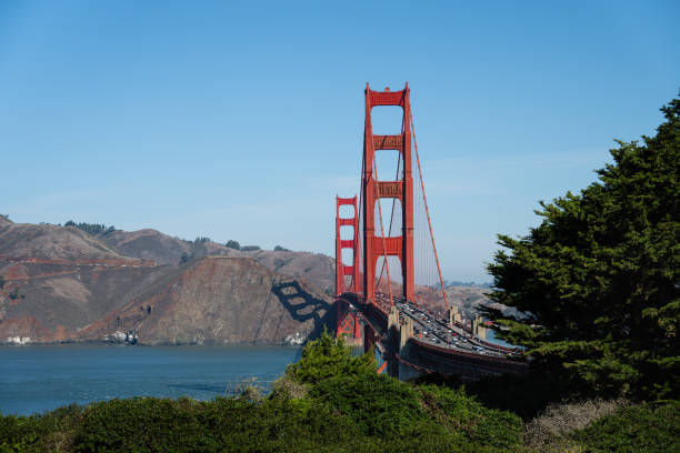 The iconic Golden Gate Bridge in San Francisco, California, spanning across the bay with its striking red towers. This world-famous suspension bridge is a must-see landmark, offering breathtaking views of the city, water, and surrounding hills.