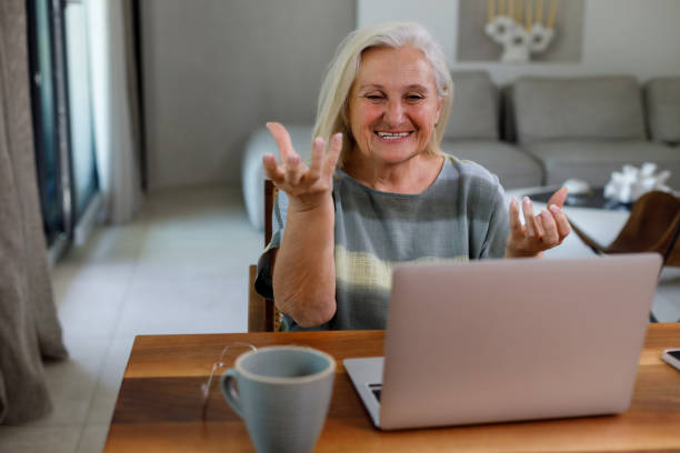 istock Elderly white woman using a digital tablet and talking on video chat 2206481151