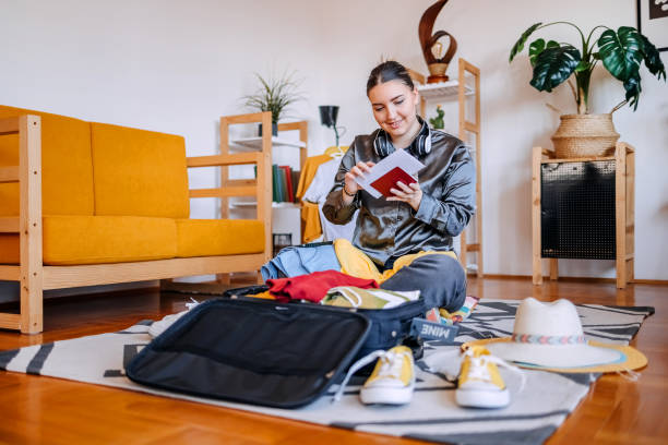 istock Young adults packing at home in suitcase preparing for trip 2206481558
