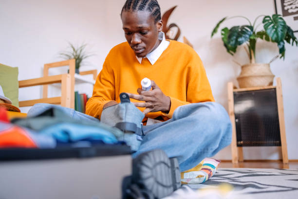 istock Young adults packing at home in suitcase preparing for trip and holding toothpaste in hand not to forget it 2206481566