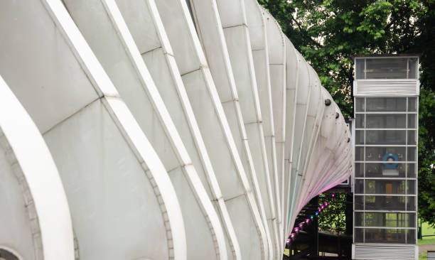 istock Aesthetic Public Crossing Bridge with Curved Square Truss Frame Design 2206481636