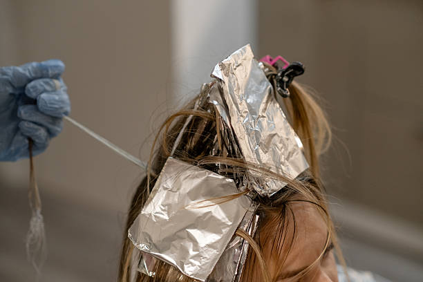 istock Hair coloring process in a salon with foil highlights during a daytime appointment 2206482639