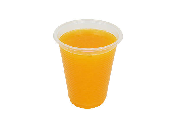 istock Fresh orange juice in plastic cup isolated 2206483413
