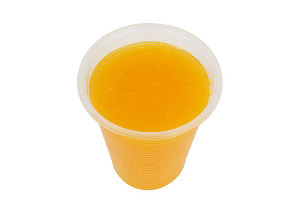 istock Fresh orange juice in plastic cup isolated 2206483433