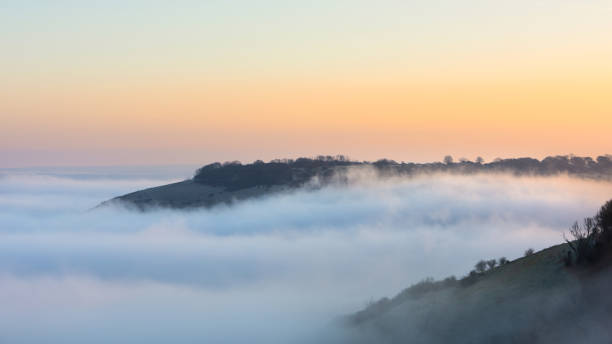 istock Stunning landscape sunrise image of atmospheric cloud inversion over South Downs escarpment 2206484930