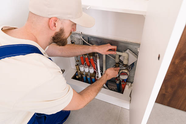 Plumber inspects heating system pipeline in residential technical boiler room