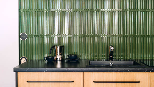 istock Modern kitchen interior featuring green accent wall and wooden cabinetry 2206485542