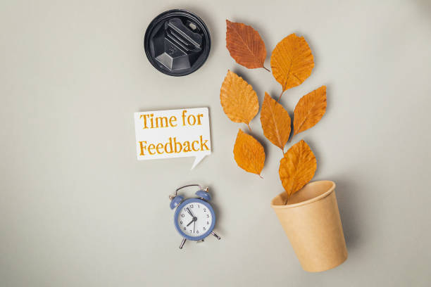 istock Clock and a cup with leaves on top of it 2206487334
