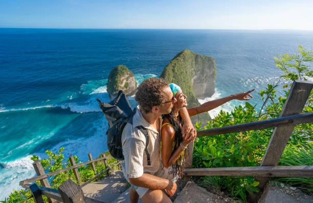istock A couple standing together while admiring an inspiring coastal and ocean view. 2206487909
