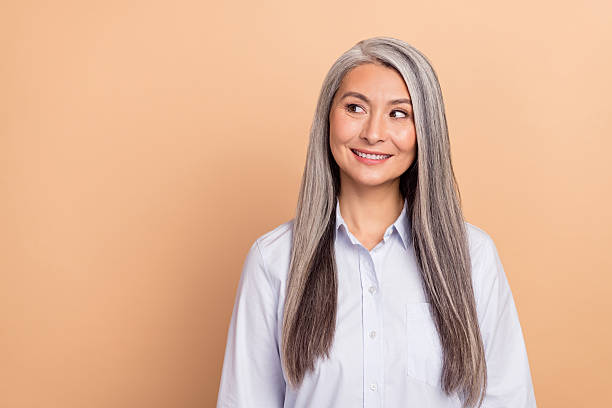 istock Photo of mature lady curious look empty space think plan smart leader isolated over beige color background 2206488241