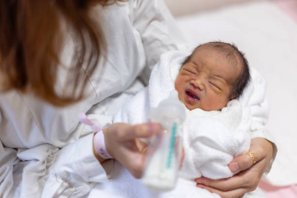 istock Mother giving milk in hospital 2206489220