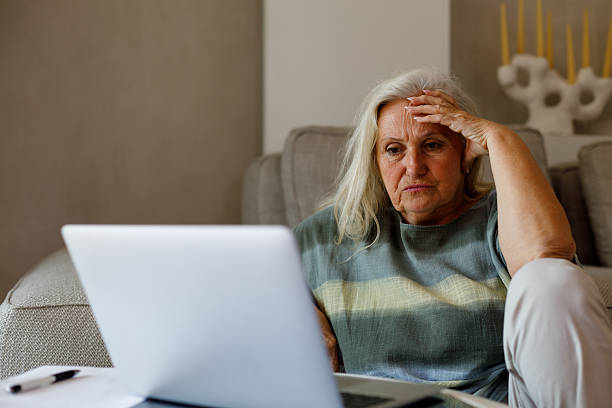 istock Worried senior woman using laptop 2206489776