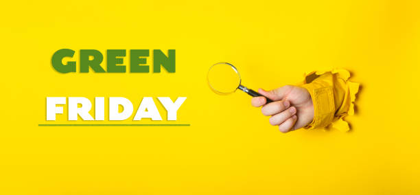istock Hand holding a magnifying glass with the words Green Friday written below 2206491186
