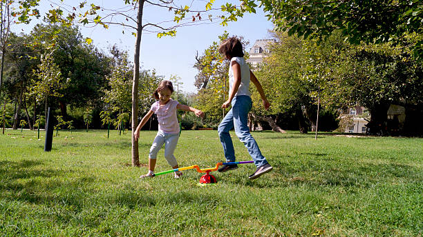 Children playing catch in a grass garden