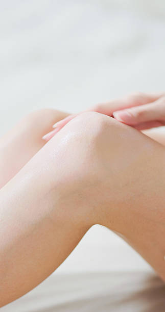 istock woman apply lotion on knee 2206494747