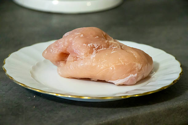 istock Fresh raw chicken breast on an elegant plate, ready to be cooked. Ideal for culinary projects, showcasing healthy eating and meal preparation 2206495083