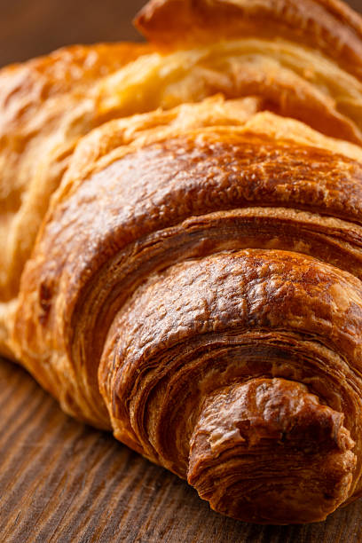 istock Delicious snack croissant on wooden background 2206496083