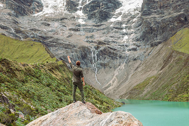 istock Man Celebrating at Scenic Mountain Lake Viewpoint 2206496501