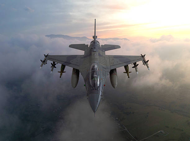 istock Fighter jet carrying bombs above the clouds 2206498477