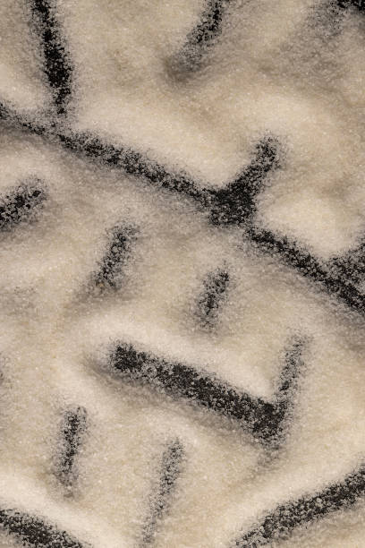istock close-up of white granulated sugar on black slate 2206504203