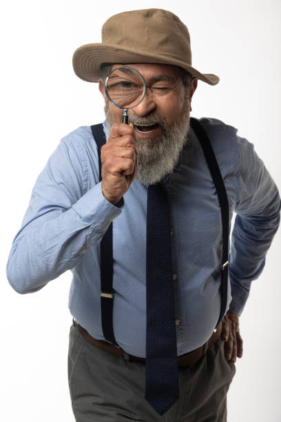 istock Detective looking through magnifying glass on white background 2206504285