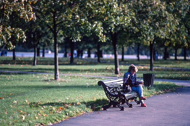 Woman Reading on Bench, Hyde Park London 1970s