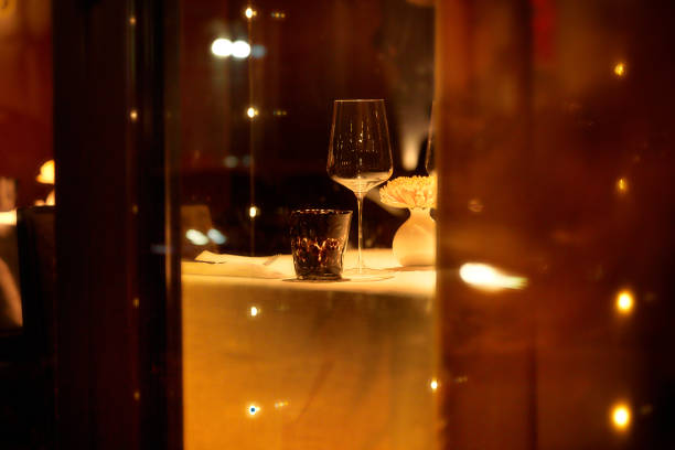 istock Wine glasses on a table in a restaurant at night. Selective focus. 2206508982