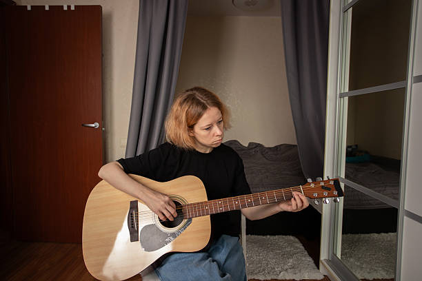 istock Guitar lessons at home, focused person on fretboard practice, learning instrument basics of rock and country. 2206510921